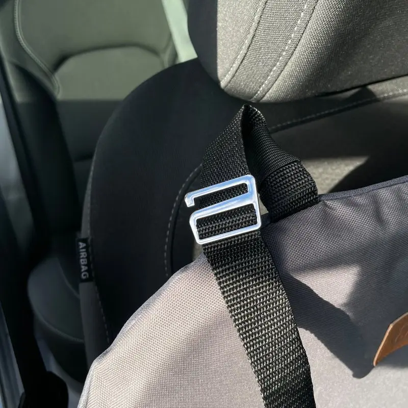 Close-up of the your GEAR Frontera dog car seat attached to a car seat with a sturdy adjustable strap and metal buckle, showing durable fabric and secure installation for safe pet transport.